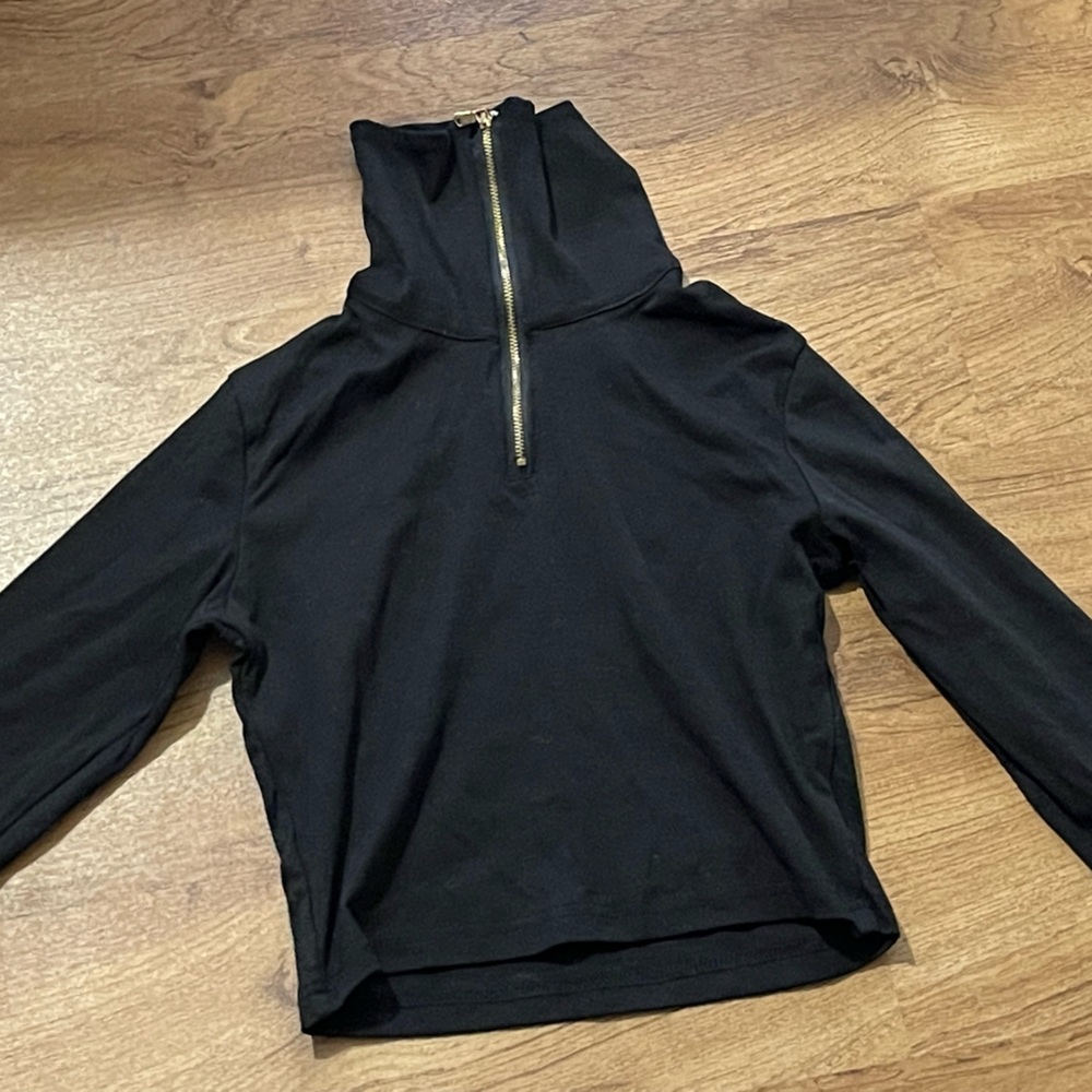 Long sleeve crop top. Can be worn with zipper down.